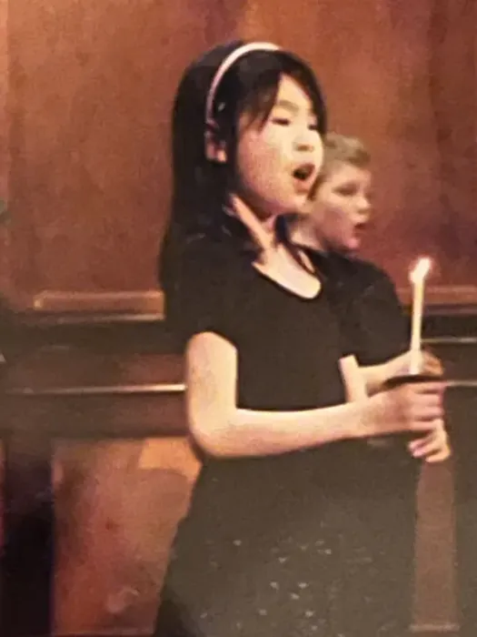 Amy singing in a choir performance