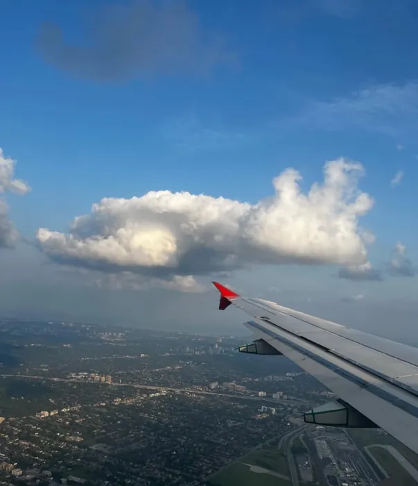 The view from a plane window over the clouds