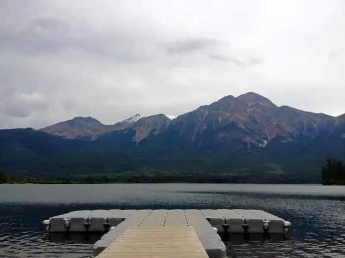 Mountains over a calm lake with a dock